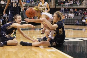 Claire DeBoer and Gretchen Shirar, both '13, battle for a loose ball in the first quarter of the state finals. The Blue Devils fell to Grand Haven in overtime. 