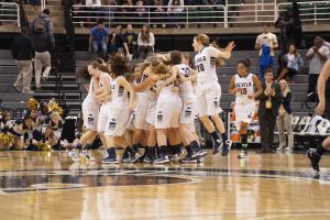 The Lady Blue Devils celebrate after beating Dexter in the state semi-finals. They will play Grand Haven in the state finals. 